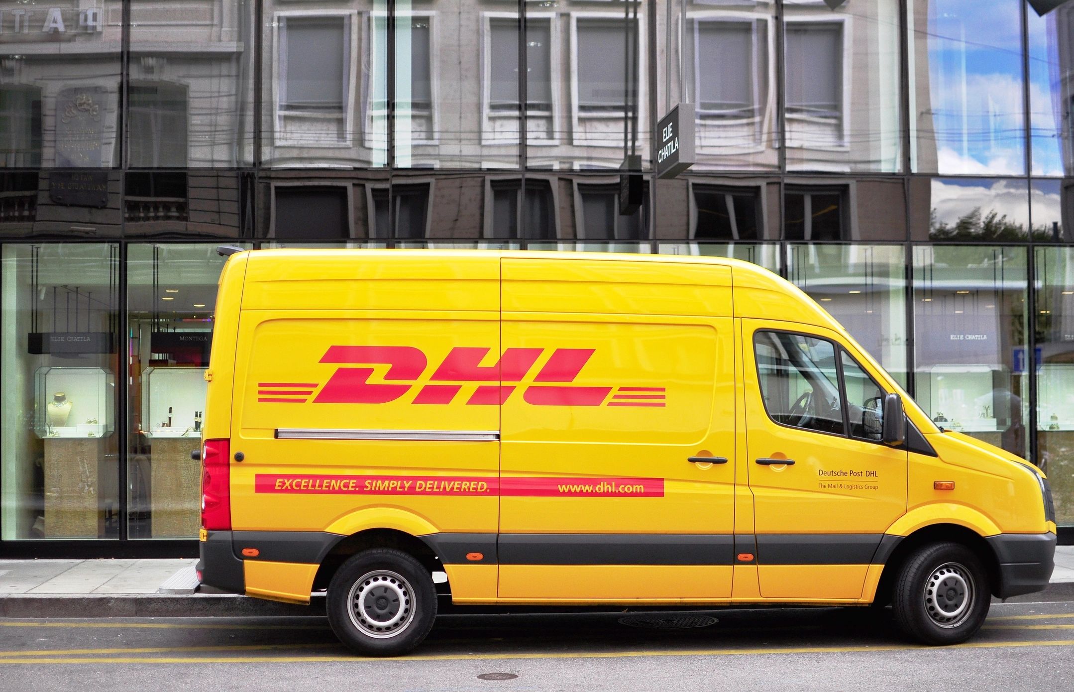 GENEVA - SEPTEMBER 3: DHL van in the street of Geneva on September 3, 2015. DHL is a company providing international delivery services.